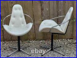 Mid century modern pair atomic style cream vinyl swivel chairs