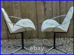 Mid century modern pair atomic style cream vinyl swivel chairs