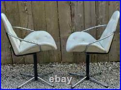 Mid century modern pair atomic style cream vinyl swivel chairs