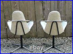 Mid century modern pair atomic style cream vinyl swivel chairs