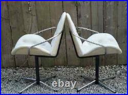 Mid century modern pair atomic style cream vinyl swivel chairs