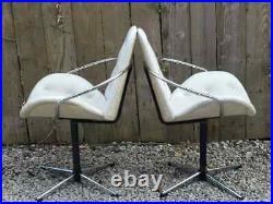 Mid century modern pair atomic style cream vinyl swivel chairs